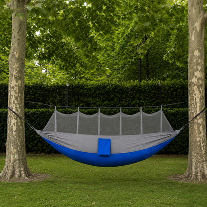 Gray double hammock between two park trees, grey over royal blue, mosquito net up