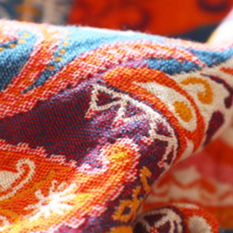 Close-up of the cotton gauze folded over, showing the woven pattern in orange, purple and teal