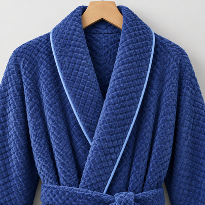 Close-up of the blue bathrobe's shawl collar crossing into a V, edged with lighter blue piping