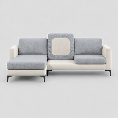 Cream L-shaped sofa face-on with grey stretch cushion covers, one back cushion turned to show the elastic underside