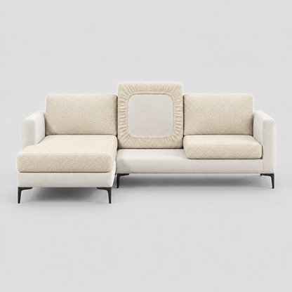 Cream L-shaped sofa face-on with beige stretch cushion covers, one back cushion turned to show the elastic underside