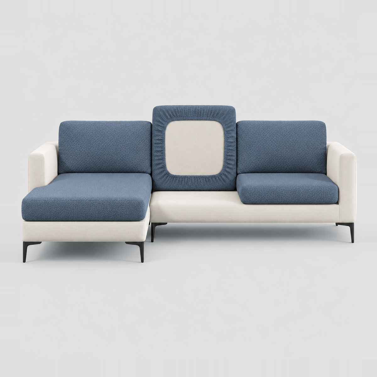 Cream L-shaped sofa face-on with slate stretch cushion covers, one back cushion turned to show the elastic underside