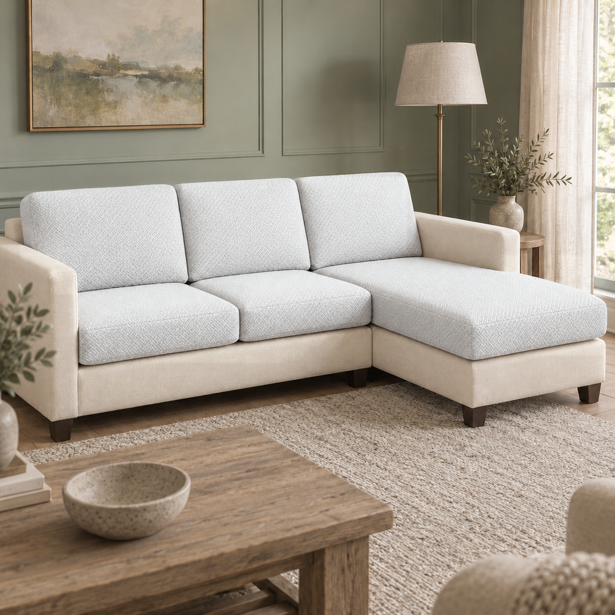 Sectional sofa with white stretch covers on its back, seat and chaise cushions in a sage green panelled living room