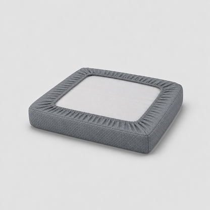 Underside of a covered seat cushion showing the charcoal cover gathered by elastic into a border on all four sides