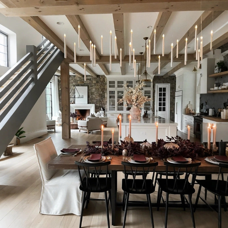 Floating LED candles hanging in rows from a beamed ceiling over an autumn dining table