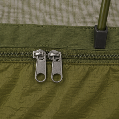 Macro of the bug net zip: one track carrying two metal sliders side by side, with the arch bar foot alongside