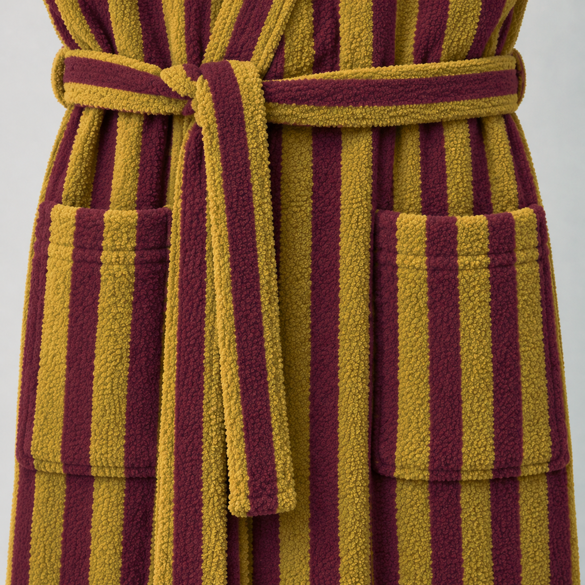 Close-up of the mustard and burgundy bathrobe's tied belt and patch pocket
