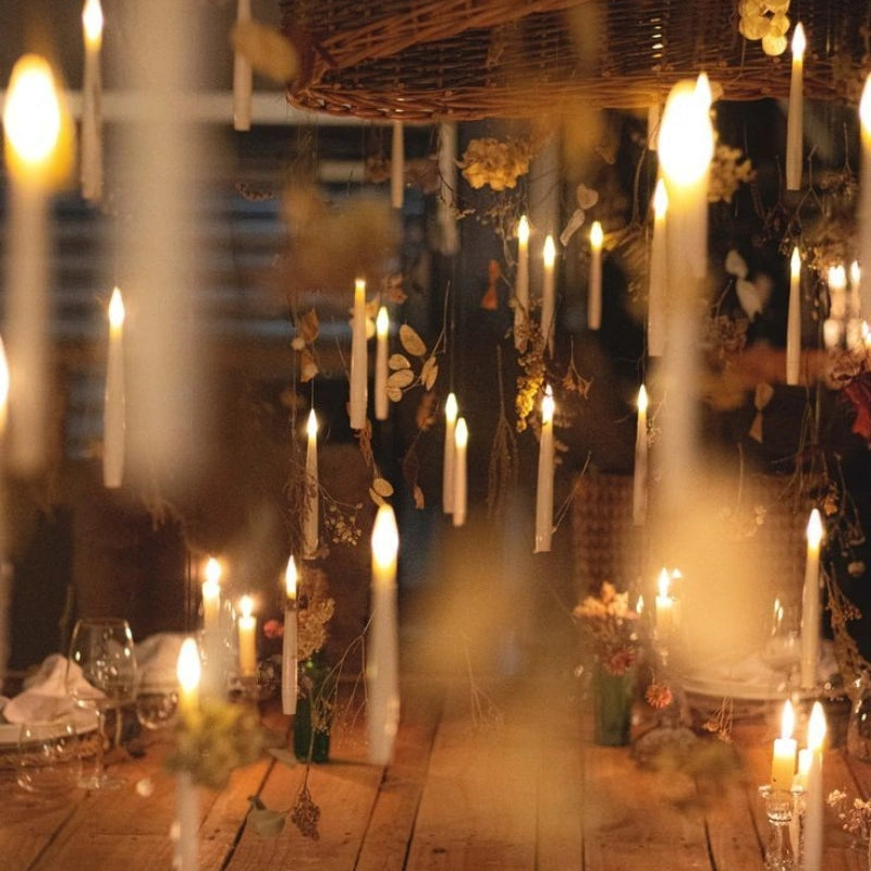Floating LED candles above a barn table dressed with dried flowers