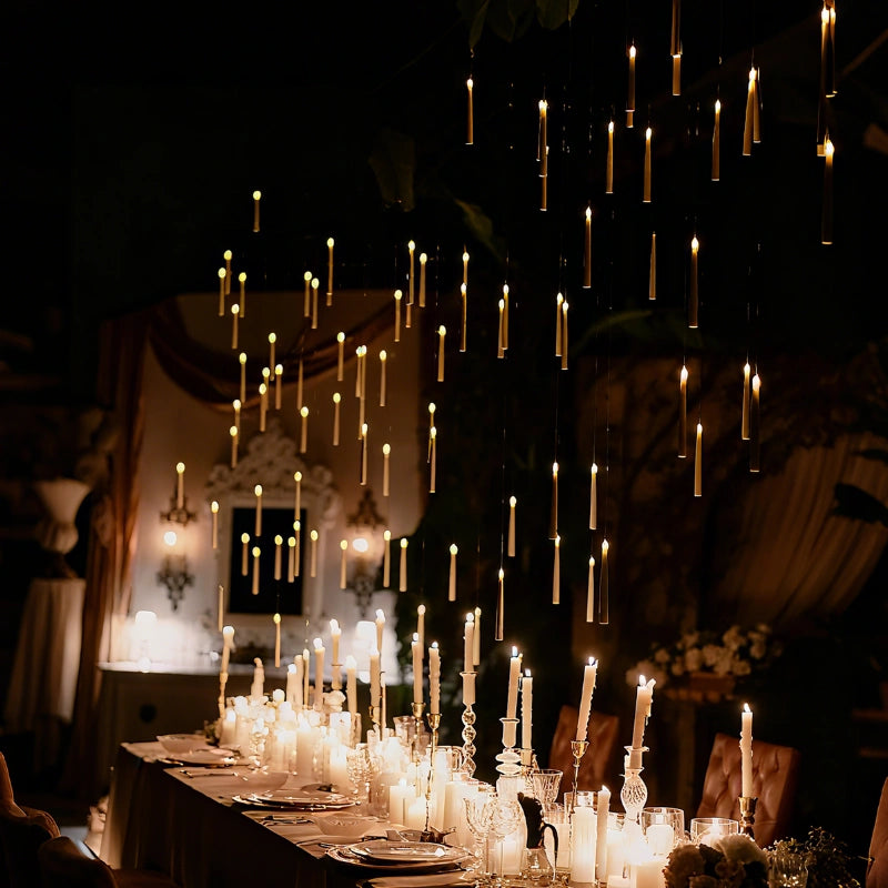 Floating LED candles above a long candlelit table in a dark ballroom