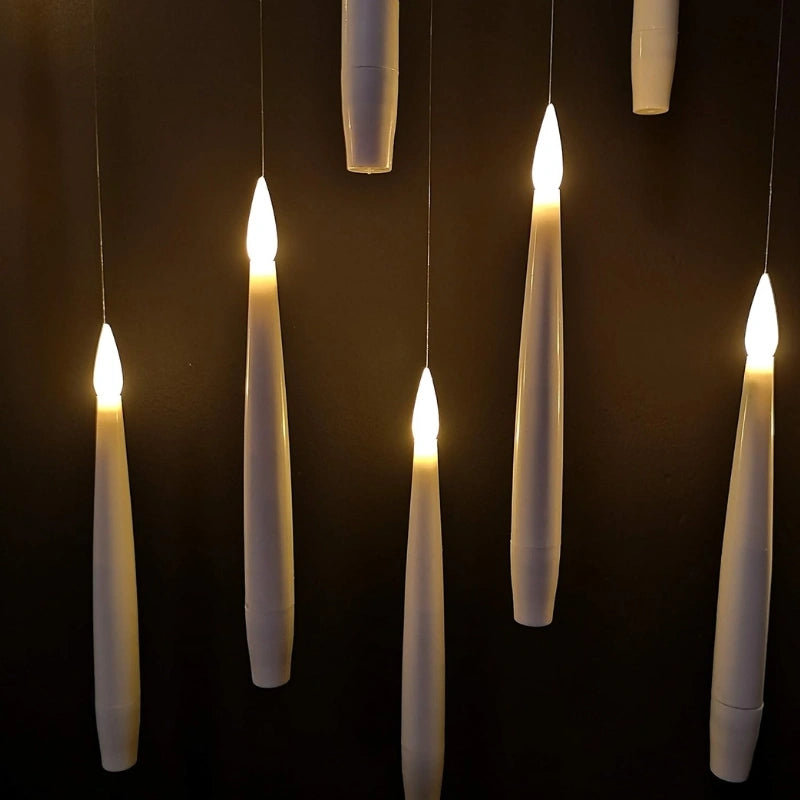 Close view of six ivory LED taper candles with molded flickering flame tips