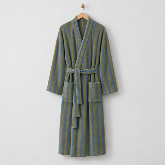 Long olive and blue striped fleece bathrobe with a kimono collar, tie belt and patch pockets, hanging on a wooden hanger on a light gray wall