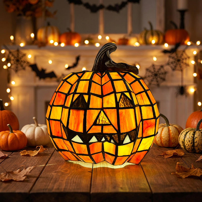 Mosaic pumpkin table lamp glowing on a wooden table in front of a mantel decorated for Halloween