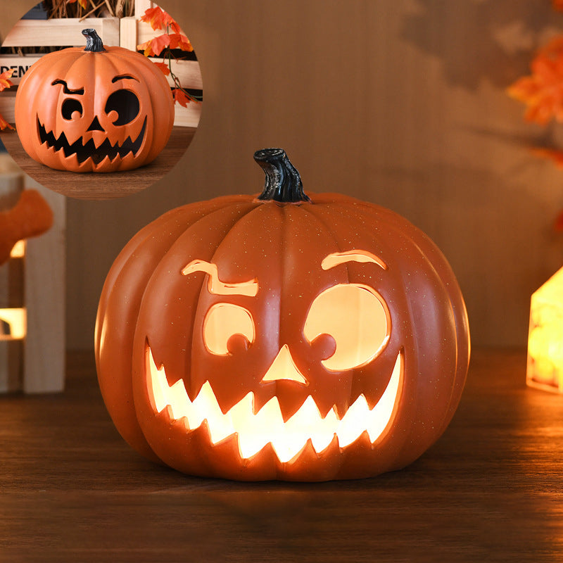 Goofy Eyes carved pumpkin lamp, a small squat pumpkin lit with mismatched round eyes and a zigzag grin