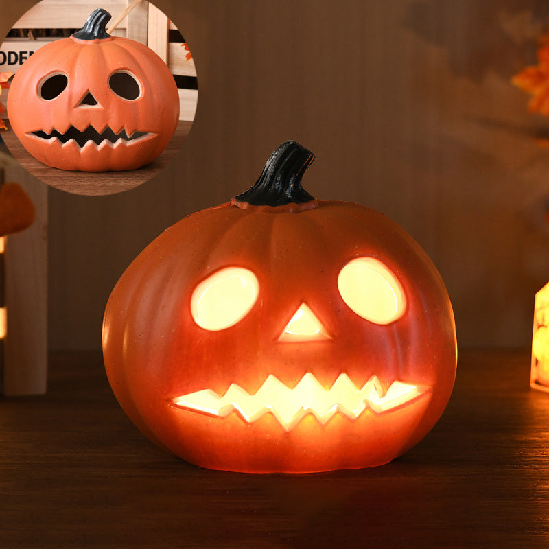 Round Eyes carved pumpkin lamp, a small pumpkin lit with two oval eyes and a zigzag mouth