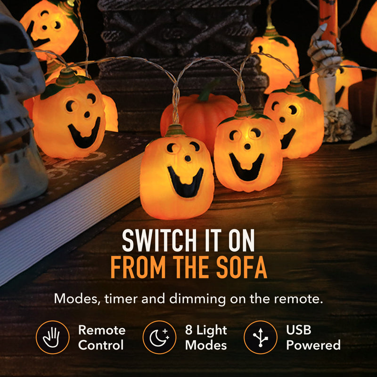 Jack-o'-lantern string lights on a dark tabletop with the words Switch It On From the Sofa, Remote Control, 8 Light Modes and USB Powered