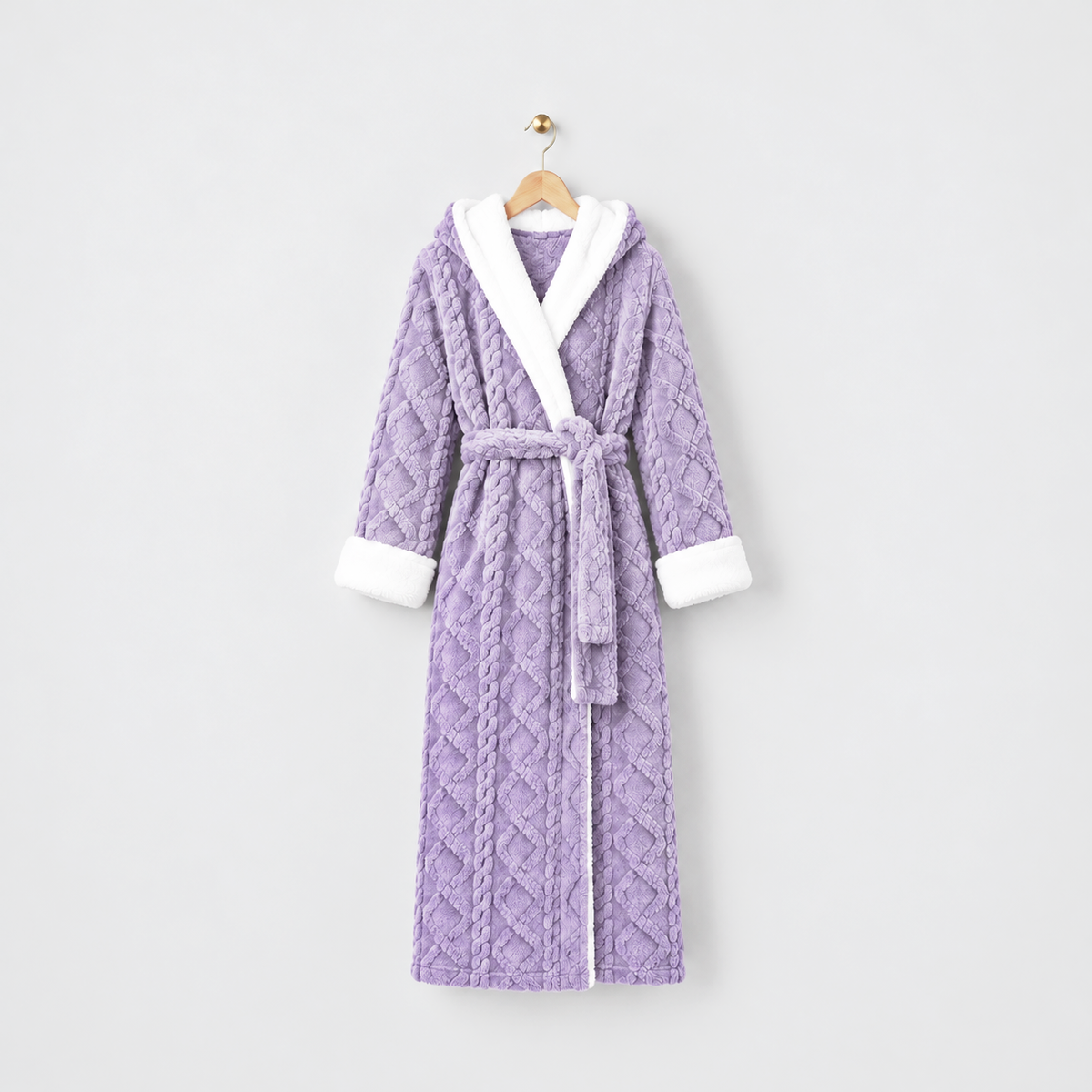 Long purple hooded plush bathrobe with white cuffs and a tied belt, on a wooden hanger against a light gray wall