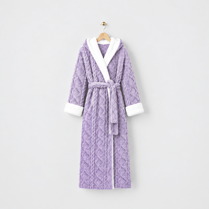 Long purple hooded plush bathrobe with white cuffs and a tied belt, on a wooden hanger against a light gray wall