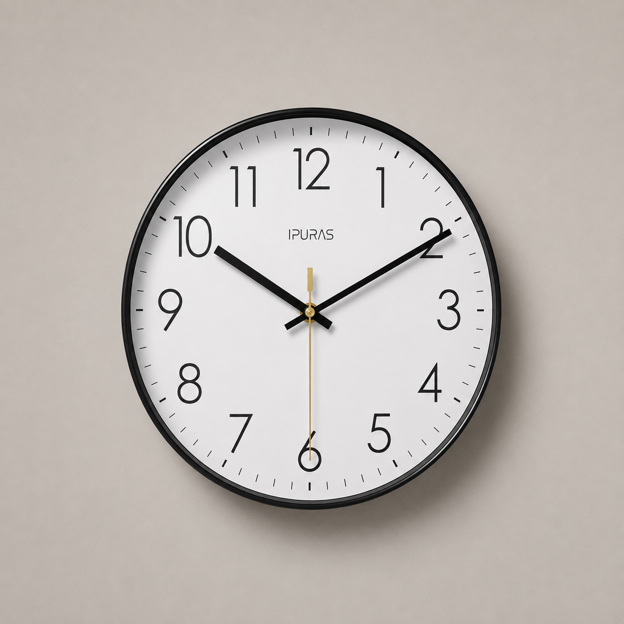 Black wall clock with a white dial and thin black Arabic numerals, on a warm grey studio background