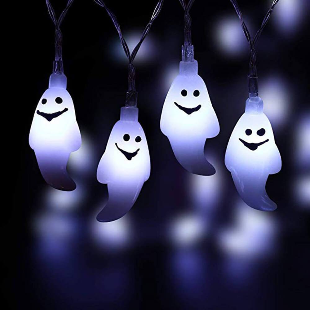 Close view of four cool white lit ghost pendants hanging from clear twisted wire