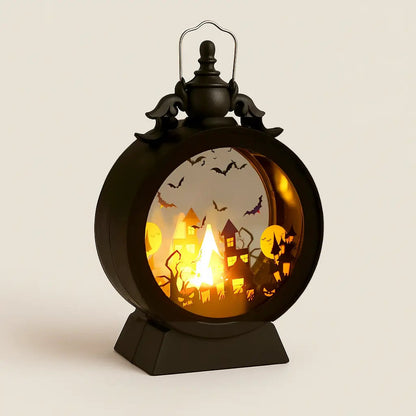 Halloween lantern with the castle scene lit, photographed square on against a plain pale background