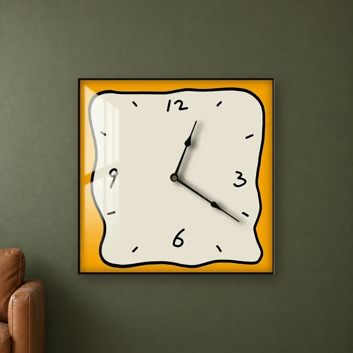 Square wall clock with a wavy doodle-style outline, a beige face and an orange border, hanging centred on an olive green wall beside a leather chair