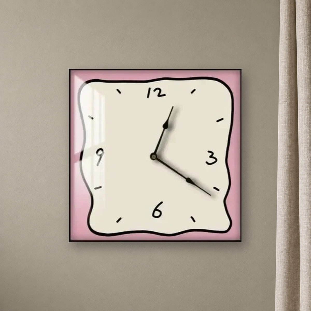 Square wall clock with a wavy doodle-style outline, a beige face and a pink border, hanging centred on a greige wall beside a linen curtain