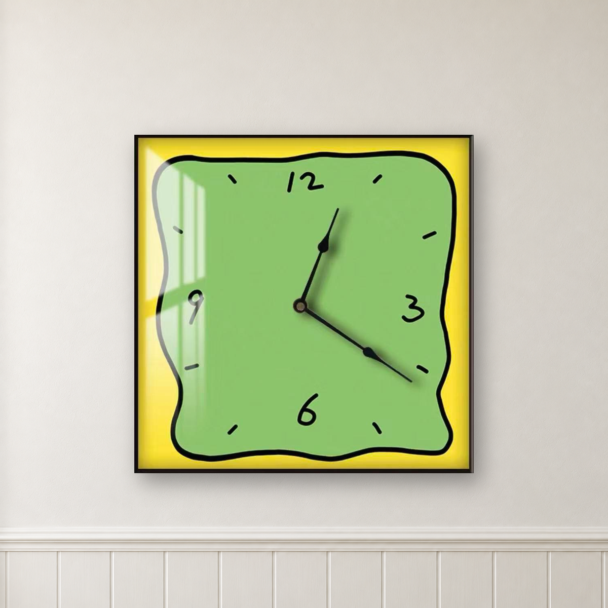 Square wall clock with a wavy doodle-style outline, a green face and a yellow border, hanging centred on a white wall above wainscot panelling