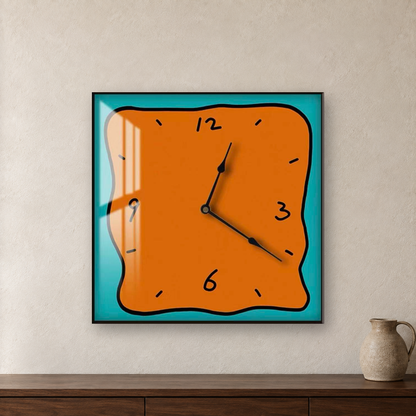 Square wall clock with a wavy doodle-style outline, an orange face and a teal border, hanging centred on an oatmeal plaster wall above a walnut sideboard