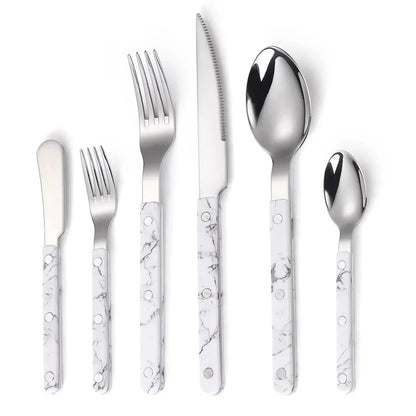 White marble-look handled six piece set, knife, fork, small fork, spoon, teaspoon and butter knife, laid out on white