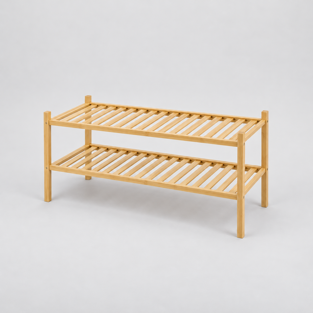 Empty 2 tier bamboo shoe rack with slim square posts and slatted shelves on a light grey background