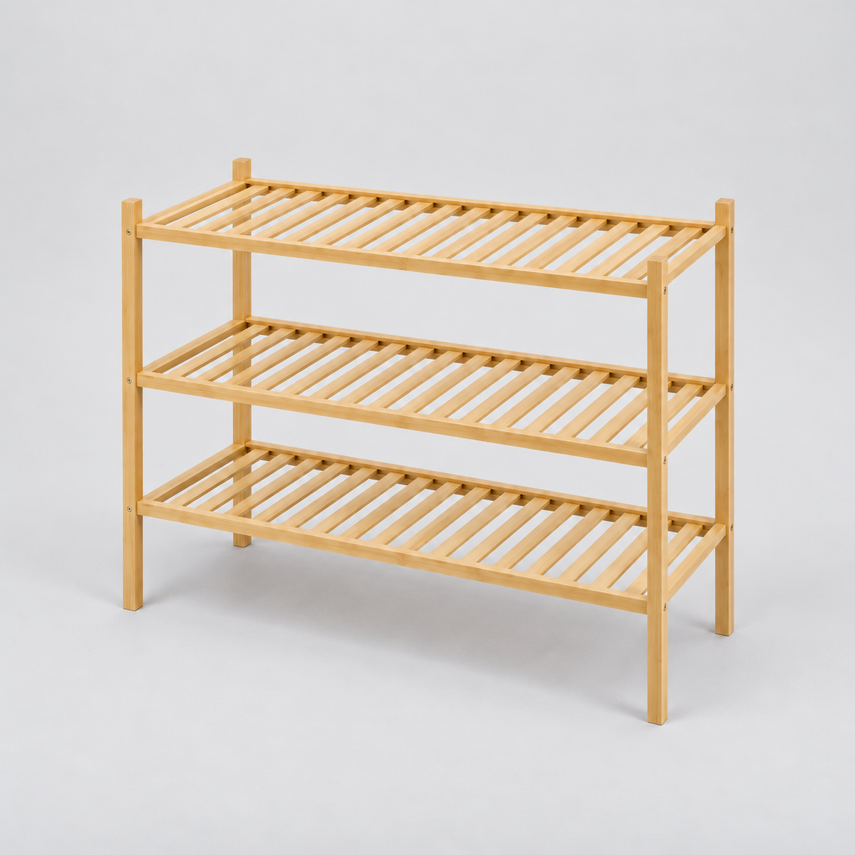 Empty 3 tier bamboo shoe rack with slim square posts and slatted shelves on a light grey background