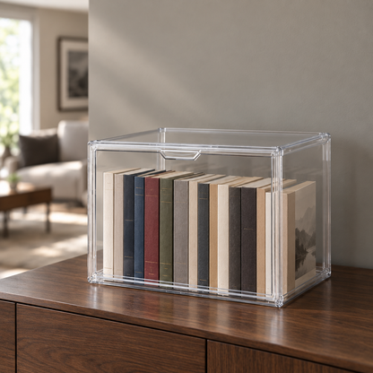 Medium clear stackable storage box with a drop front door on a walnut sideboard, holding paperback books
