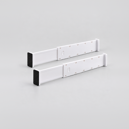 Two short white expandable drawer dividers side by side on a light grey background