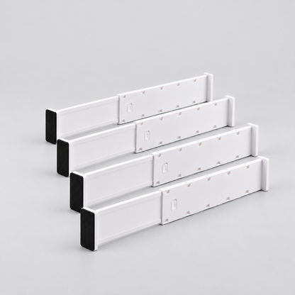 Four long white expandable drawer dividers lined up on a light grey background