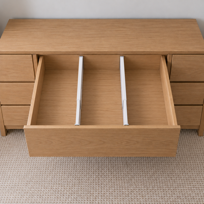 Two long drawer dividers splitting an empty oak dresser drawer into three lanes, front to back