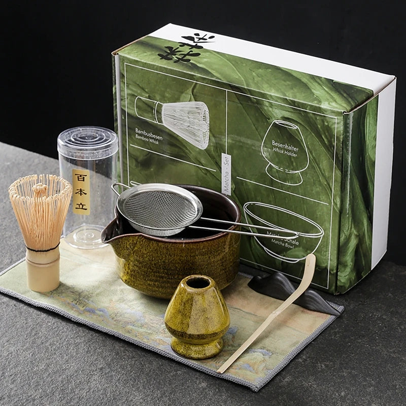 Yellow seven-piece matcha kit: spouted bowl with sifter, bamboo whisk, yellow whisk holder, bamboo scoop, scoop rest and printed cloth