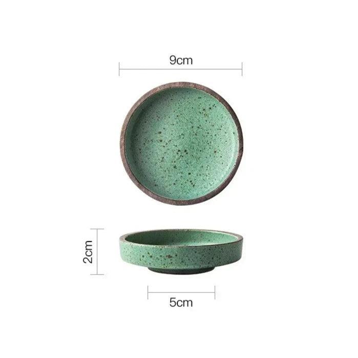 Green speckled ceramic dipping bowl seen from above and from the side, 9 cm across and 2 cm tall