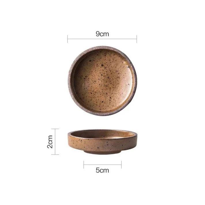 Brown speckled ceramic dipping bowl seen from above and from the side, 9 cm across and 2 cm tall