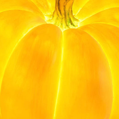 Close view of a lit resin pumpkin lamp below the stem, the grooves between the lobes glowing brighter