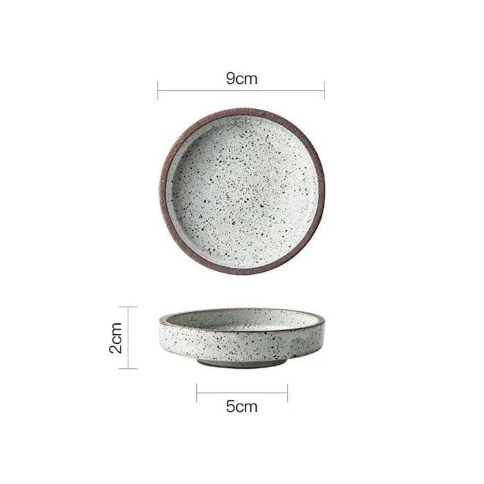 White ceramic dipping bowl with black speckles seen from above and from the side, 9 cm across and 2 cm tall