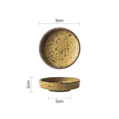 Yellow speckled ceramic dipping bowl seen from above and from the side, 9 cm across and 2 cm tall