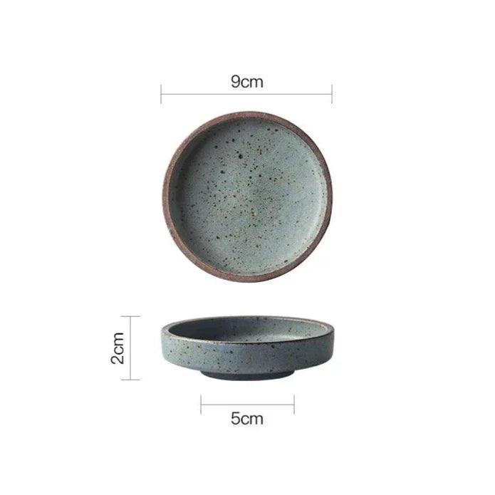 Gray speckled ceramic dipping bowl seen from above and from the side, 9 cm across and 2 cm tall