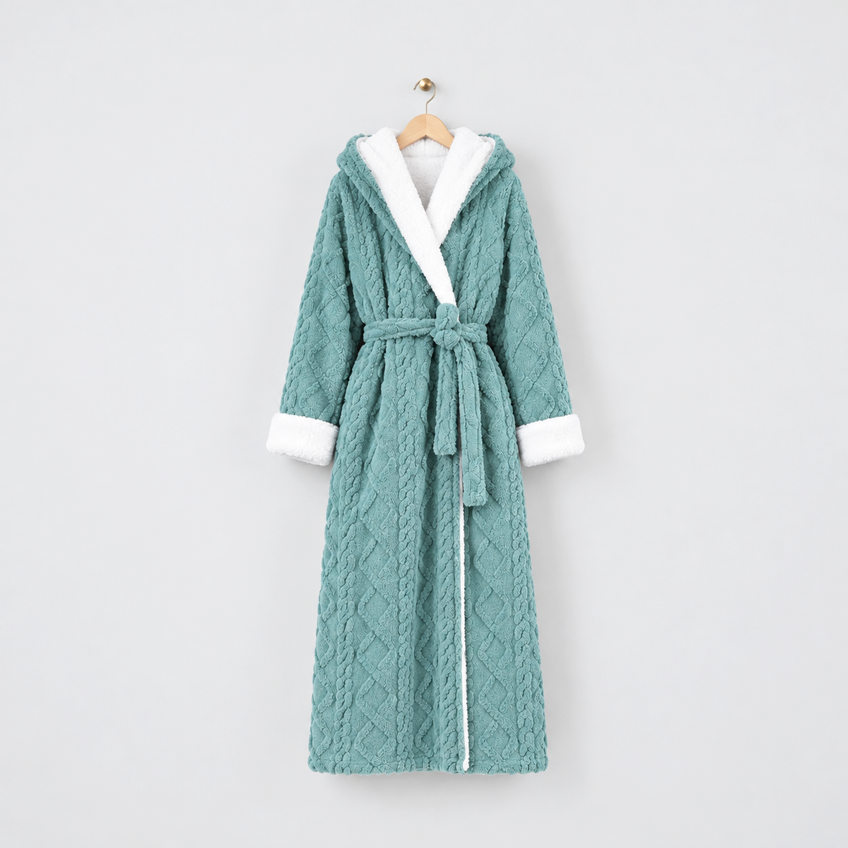 Long teal hooded plush bathrobe with white cuffs and a tied belt, on a wooden hanger against a light gray wall
